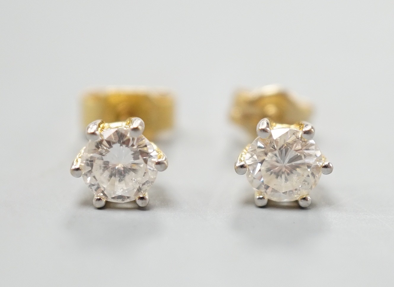 A pair of yellow metal and solitaire diamond set ear studs, gross weight 1.2 grams, each stone weighing approx. 0.33ct.